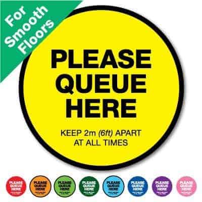 Round yellow Social Distancing Sticker for smooth floors that says "Please Queue here" on the top plus 8 other colours o the bottom