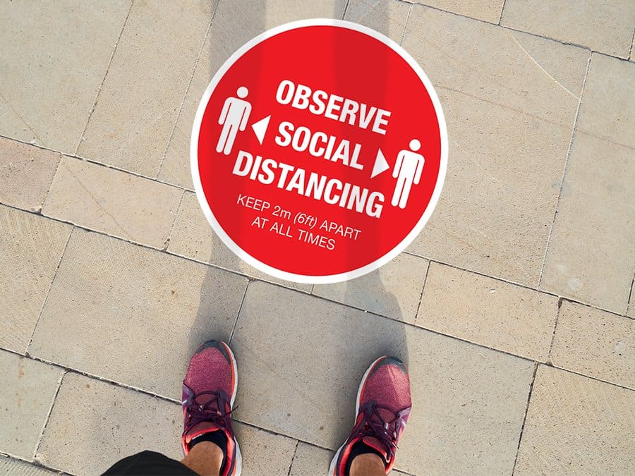 Social Distancing Sticker for outdoor usage that says "Observe Social Distancing" on a paved ground